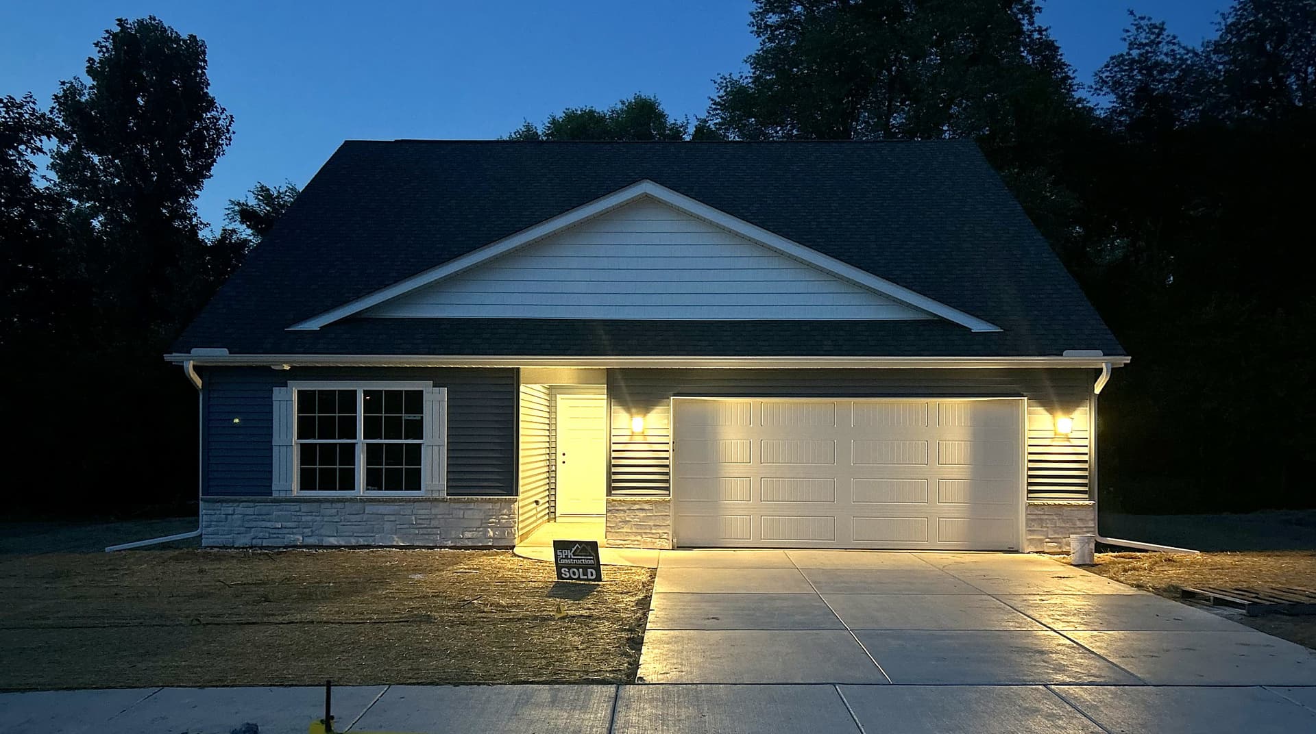 A new Fernway Road home lit up at dusk